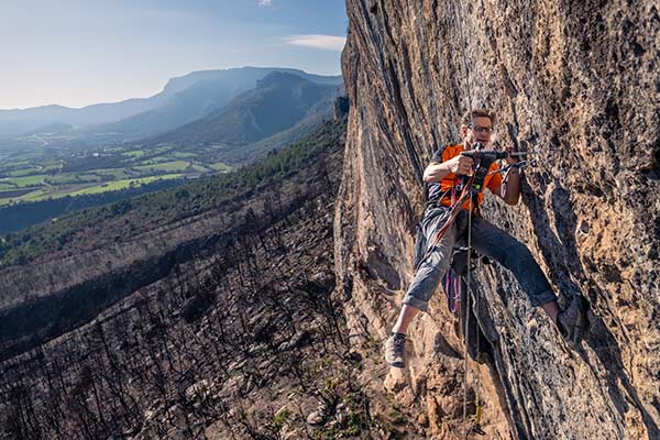 Chris Frick drilling in the Oliana climbing area that was hit by the fire. Image: Nils Ohlendorf Photography