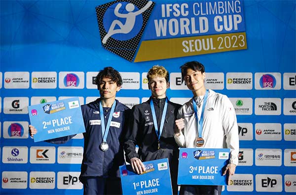 Podium of the second Bouldering World Cup of the 2023 season: Tomoa Narasaki, Mejdi Schalck and Jongwon Chon. Image: Dimitris Tosidis/IFSC