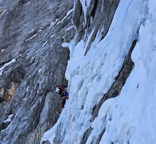 The Levicnik-Fomin-Muircheartaigh rope team on the key pitch of the Dream Couloir on the Triglav north face. Image: Naoise Ó Muircheartaigh